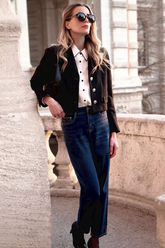 a lady in a white shirt, a black crop jacket and a pair of jeans